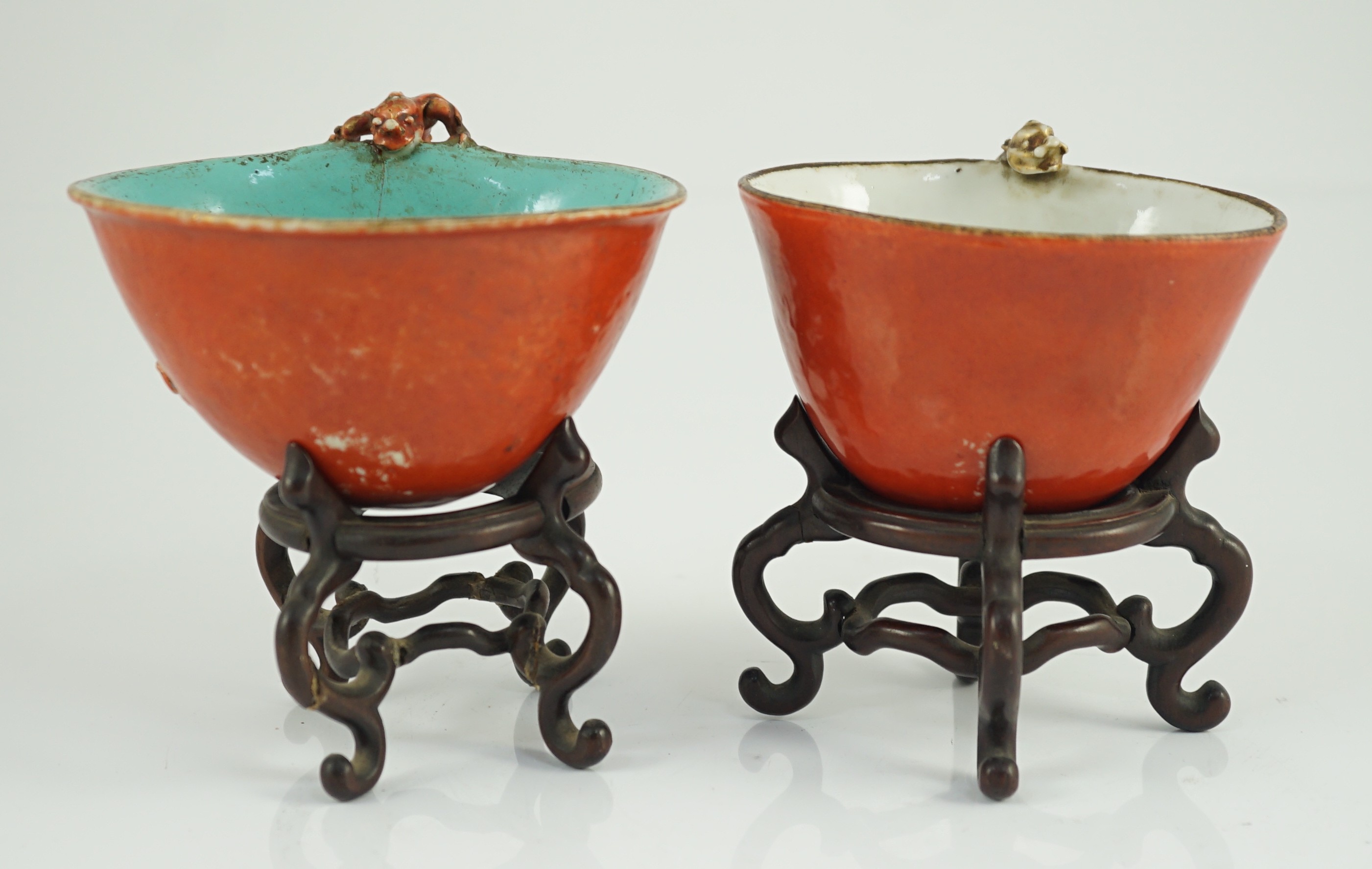 Two similar Chinese coral ground libation cups, late 18th/early 19th century, 10.5cm and 11.5cm across, wood stands